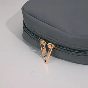 Durable gray portable makeup storage bag with a focus on its premium golden double zippers