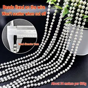 Detailed macro view of 6mm white faux pearl bead chain for DIY wedding decoration.