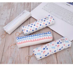Detailed view of four colorful PU pencil cases with cartoon patterns and keychains