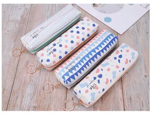 Detail of four colorful patterned PU pencil cases with rose gold ring zippers