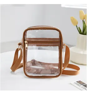 Small transparent PVC waterproof crossbody bag with adjustable brown strap and zipper pocket