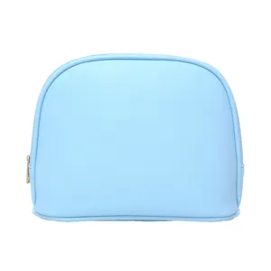 Minimalist light blue shell-shaped cosmetic bag with textured finish and gold zipper.