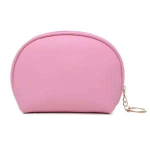 Minimalist pink semi-circle shell cosmetic bag with textured finish and golden zipper