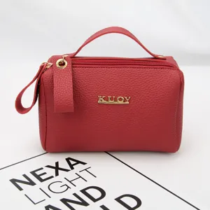 Portable red pebble texture makeup bag with sturdy top handle and gold KUOY logo