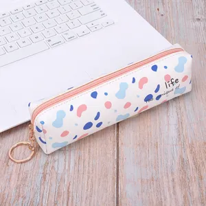 Minimalist cartoon PU pencil case with colorful pattern and gold keyring on laptop