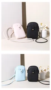 Close-up of minimalist crossbody phone bags in pink, blue, and black textured leather