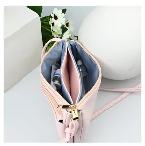 Interior view of pink minimalist PU crossbody bag showing dual compartments.