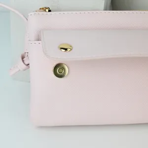 Elegant light pink saffiano leather crossbody phone bag with gold magnetic snap closure
