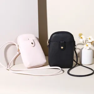 Minimalist crossbody mobile phone bags in black and pink with textured PU leather finish