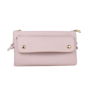 Stylish light pink Saffiano leather crossbody phone bag for women with gold decorative studs