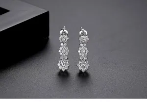 Detailed macro shot of sparkling zircon flower drop earrings with petal design.