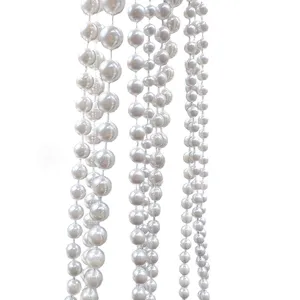 Macro detail of 10mm white faux pearl bead strands for wedding decor and DIY crafts