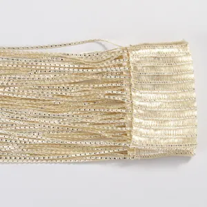 Detail view of champagne gold S-shaped fringe curtain for doorway and window decoration