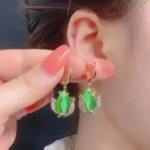 Elegant gold tulip hoop earrings with green stones and sparkling white rhinestones