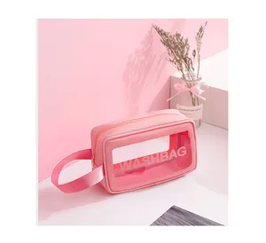 Macro detail of a pink waterproof travel cosmetic bag with a clear window and handle