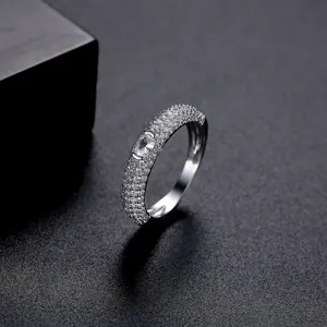 Elegant micro-paved zircon ring with oval center stone on dark textured background