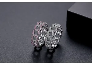 Primer plano de anillos de cadena cubana de plata con piedras rosas
