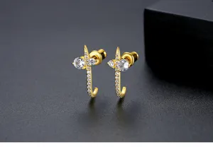 Macro view of gold-plated copper earrings featuring sparkling cubic zirconia stones