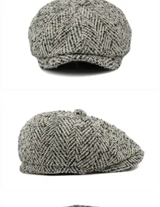 Detailed view showing the herringbone tweed texture of a vintage grey wool newsboy cap.