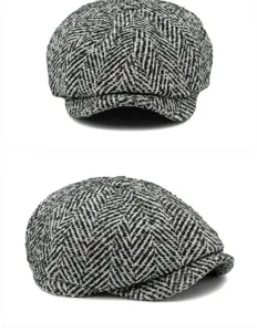 Detailed view of grey herringbone newsboy cap showing tweed texture and 8-panel design