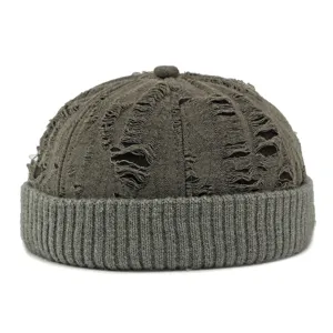 Distressed retro docker hat with ribbed knit cuff for a casual and stylish yuppie look.