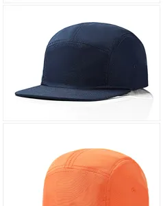 Detail view of navy blue and orange lightweight five-panel quick-dry caps