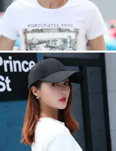 Detailed view of a stylish black baseball cap with an extended brim worn by a female model