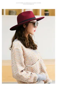 Profile view of a stylish burgundy felt fedora hat worn by a model in a cozy knit sweater