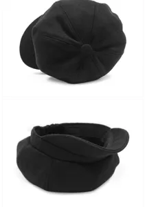 Close-up view of the top and rear details of a black wool newsboy hat with elastic