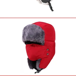 Close-up of red winter trapper hat with integrated windproof mask and grey faux fur lining.