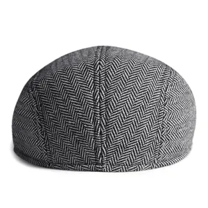Classic men's black and white herringbone flat cap with vintage British ivy style