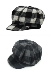 Close-up of black and white and gray plaid woolen newsboy hats shown in a detail view.
