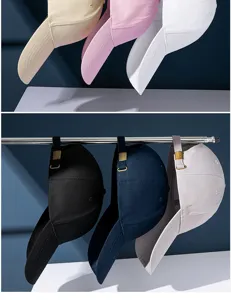 Close-up of various colors of long-brim sun protection baseball caps displayed on a rack