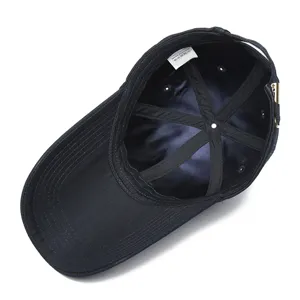 Interior view of black long brim cotton baseball cap showing lining and care label