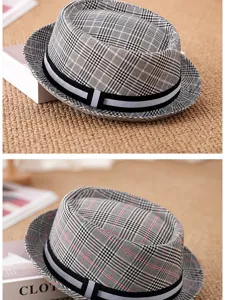 Detailed view of the classic plaid pattern and woven texture of the British trilby hat