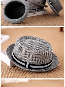 Close-up of a classic plaid fedora hat with short brim and striped band decoration
