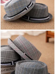 Close-up view of classic plaid fedora hats with short brims and black ribbon bands.