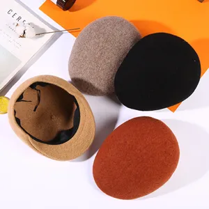 Assorted wool berets and flat caps in warm autumn colors for men and women