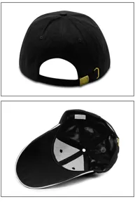 Detail showing the adjustable metal buckle and inner cotton label of the black baseball cap.