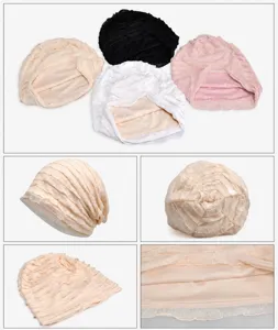 Macro view of pleated cotton turban hat in beige showing soft breathable fabric texture