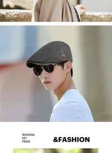 Detail of man wearing a grey wool beret flat cap in a British retro fashion style.
