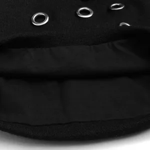 Close-up of a punk style black knitted beanie hat with silver metal ring accents