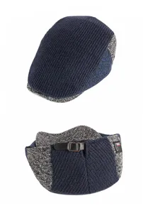 Macro detail view of a knitted navy blue newsboy cap featuring an adjustable faux leather strap.