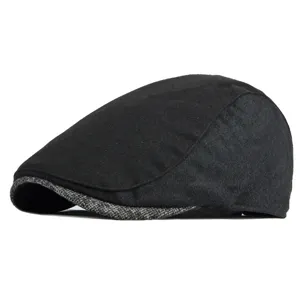 Classic retro British style black newsboy flat cap for men with a grey patchwork brim