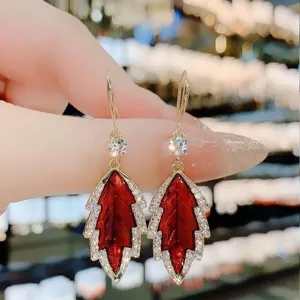Close-up of sparkling red oil-dripped leaf earrings with micro-inlaid rhinestones