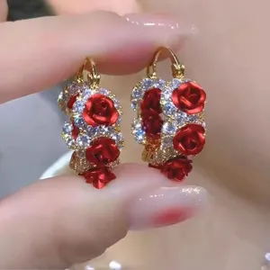 Detailed close-up view of vintage style red rose hoop earrings with shiny white crystals