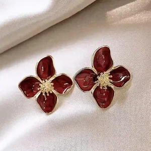Macro view of vintage French red flower stud earrings with golden textured center
