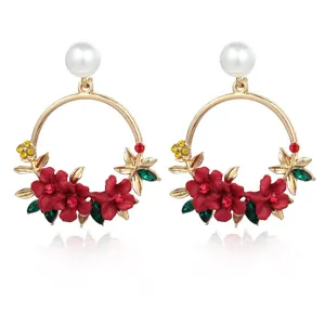 Elegant gold-tone hoop earrings featuring red flowers, vibrant crystals, and white pearls.