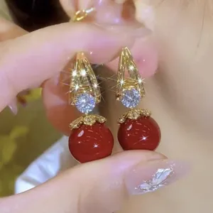 Detailed view of elegant French vintage red pearl earrings with sparkling zircon accents