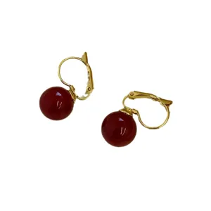 Detailed close-up of French vintage dark red bead earrings with elegant gold leverback closures